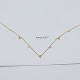 A close-up image of the Triad Necklace, featuring three delicate interlocking rings on a stainless steel chain, showcasing its sleek, polished finish.