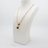 Close-up of the Chain Lock Heart Necklace showing the non-adjustable paperclip chain links and heart lock charm in polished 18K gold-plated stainless steel with a lobster clasp closure.