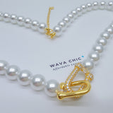Close-up of the Regalia Pearl Necklace featuring lustrous imitation pearls and a dazzling pavé cubic zirconia clasp plated in 18K gold. The detailed shot highlights the elegant clasp design and the smooth pearl finish, offering a clear view of the premium craftsmanship and luxurious texture of this Wava Chic piece.