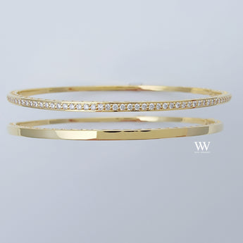 two 14K gold and diamond bangles