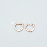 a pair of mini huggies hoops earrings set with little diamonds. 