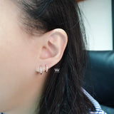 a pair of mini huggies hoops earrings set with little diamonds. 