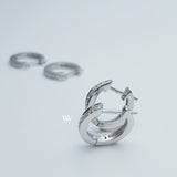 a pair of mini huggies hoops earrings set with little diamonds. 