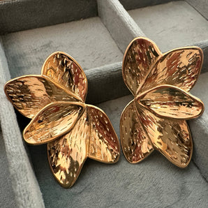 Close-up view of the Baroque Gold Studs showcasing their intricate sculptural design and glossy 14K gold plating. The textured, uneven surface mimics classic baroque patterns, giving a luxurious and bold statement look. Stainless steel base visible in fine detail.