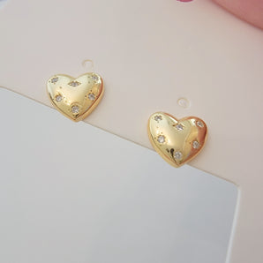Close-up of the Starry Heart Studs showcasing their sculpted heart shape in polished 925 sterling silver. The electroplated finish enhances their high-shine, reflective surface, while the design captures modern elegance with a hint of playful boldness. Weight and metal texture clearly visible.