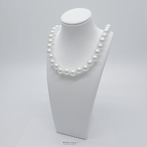 Close-up of the Pearl Affair Necklace featuring uniform imitation pearls (available in 10mm, 6mm, or 4mm sizes), 18K gold plated titanium steel base, and a secure lobster clasp closure. Glossy pearls and sleek gold finish highlight the craftsmanship.