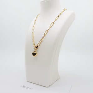 Close-up of the Chain Lock Heart Necklace showing the non-adjustable paperclip chain links and heart lock charm in polished 18K gold-plated stainless steel with a lobster clasp closure.
