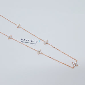 Close-up of the Blossom Drift Necklace showing a dainty floral cluster of cubic zirconia stones set on a gold-plated 925 sterling silver chain, highlighting its soft sparkle and fine detailing.
