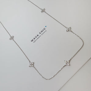Close-up of the Blossom Drift Necklace showing a dainty floral cluster of cubic zirconia stones set on a gold-plated 925 sterling silver chain, highlighting its soft sparkle and fine detailing.