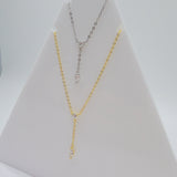 Close-up view of the Dot & Drape Diamond Necklace featuring bezel-set cubic zirconia stones along a dainty gold-plated sterling silver chain. The image highlights the precise craftsmanship and delicate drape, showcasing how each sparkling CZ stone is evenly spaced for a modern, refined look.
