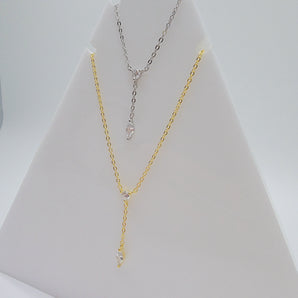 Close-up view of the Dot & Drape Diamond Necklace featuring bezel-set cubic zirconia stones along a dainty gold-plated sterling silver chain. The image highlights the precise craftsmanship and delicate drape, showcasing how each sparkling CZ stone is evenly spaced for a modern, refined look.
