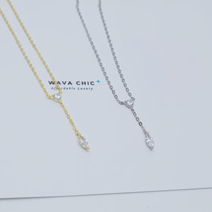 Close-up view of the Dot & Drape Diamond Necklace featuring bezel-set cubic zirconia stones along a dainty gold-plated sterling silver chain. The image highlights the precise craftsmanship and delicate drape, showcasing how each sparkling CZ stone is evenly spaced for a modern, refined look.

