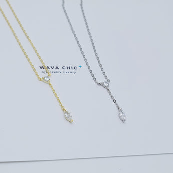 Close-up view of the Dot & Drape Diamond Necklace featuring bezel-set cubic zirconia stones along a dainty gold-plated sterling silver chain. The image highlights the precise craftsmanship and delicate drape, showcasing how each sparkling CZ stone is evenly spaced for a modern, refined look.
