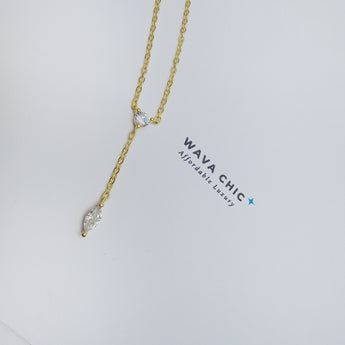 Close-up view of the Dot & Drape Diamond Necklace featuring bezel-set cubic zirconia stones along a dainty gold-plated sterling silver chain. The image highlights the precise craftsmanship and delicate drape, showcasing how each sparkling CZ stone is evenly spaced for a modern, refined look.
