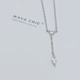 Close-up view of the Dot & Drape Diamond Necklace featuring bezel-set cubic zirconia stones along a dainty gold-plated sterling silver chain. The image highlights the precise craftsmanship and delicate drape, showcasing how each sparkling CZ stone is evenly spaced for a modern, refined look.
