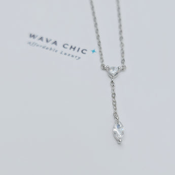 Close-up view of the Dot & Drape Diamond Necklace featuring bezel-set cubic zirconia stones along a dainty gold-plated sterling silver chain. The image highlights the precise craftsmanship and delicate drape, showcasing how each sparkling CZ stone is evenly spaced for a modern, refined look.

