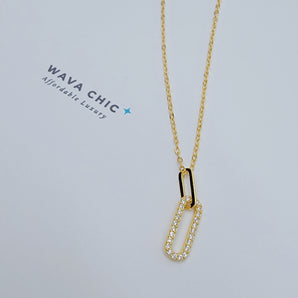Close-up of the Clip Drop Necklace featuring a modern clip-inspired pendant with cubic zirconia detailing. The pendant hangs from a fine gold-plated 925 silver chain, showcasing the clean lines, sparkle, and lightweight design of this fashion-forward accessory.