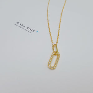 Close-up of the Clip Drop Necklace featuring a modern clip-inspired pendant with cubic zirconia detailing. The pendant hangs from a fine gold-plated 925 silver chain, showcasing the clean lines, sparkle, and lightweight design of this fashion-forward accessory.