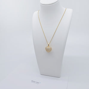 Close-up of the Apple Heart Necklace showing a heart-shaped pendant designed like an apple, paved with sparkling cubic zirconia stones. The pendant has a smooth 18K gold-plated finish, and it hangs from a sleek stainless steel chain. Crafted for durability and glamour.