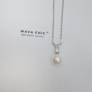 Close-up of the Bunny Pearl Necklace showing a lustrous faux pearl drop paired with a clear solitaire cubic zirconia stone set in 925 sterling silver. The design is delicate and bright, offering a graceful sparkle with a polished, refined finish.