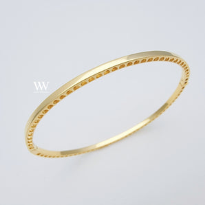 14 karat Gold bangle, designed with little holes on the sides